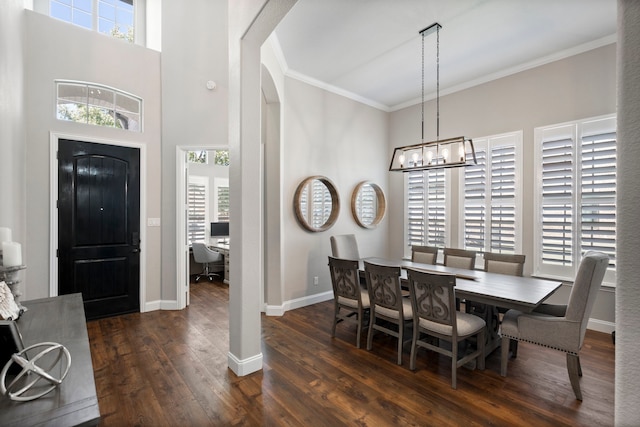 dining room with a wealth of natural light, crown molding, a notable chandelier, and dark hardwood / wood-style flooring