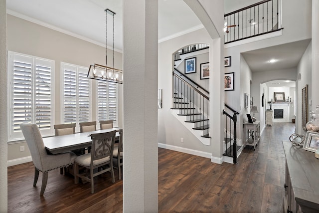 dining space with crown molding and dark wood-type flooring