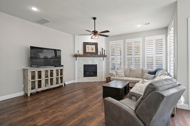 living room featuring dark wood-type flooring and ceiling fan