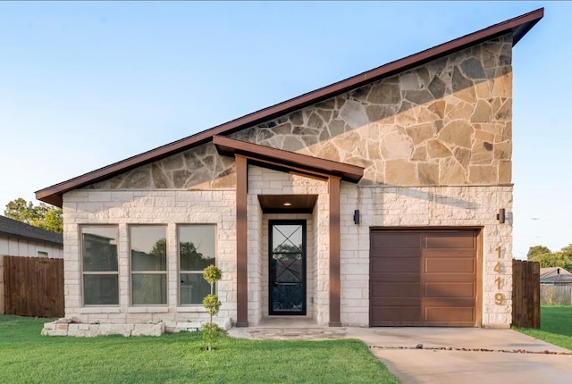 view of front facade with a front yard and a garage