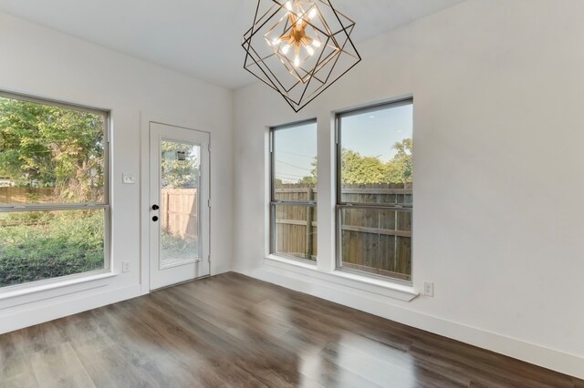 doorway with hardwood / wood-style floors and plenty of natural light