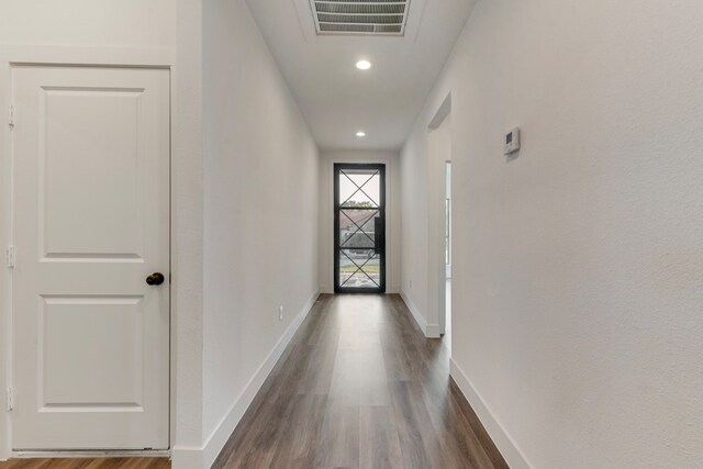 corridor featuring dark hardwood / wood-style floors