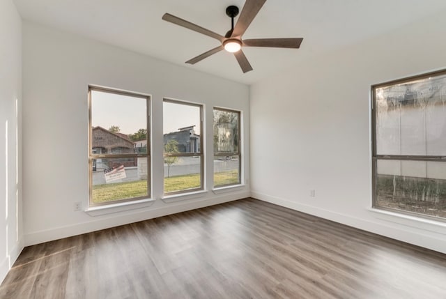 empty room with wood-type flooring and ceiling fan