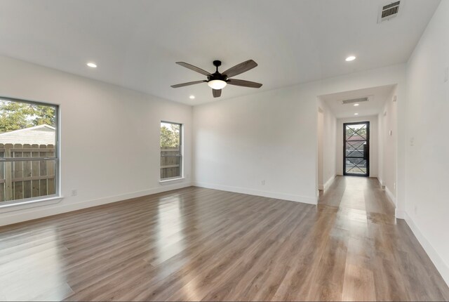 spare room featuring light hardwood / wood-style floors, plenty of natural light, and ceiling fan