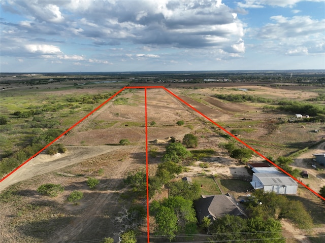 birds eye view of property with a rural view