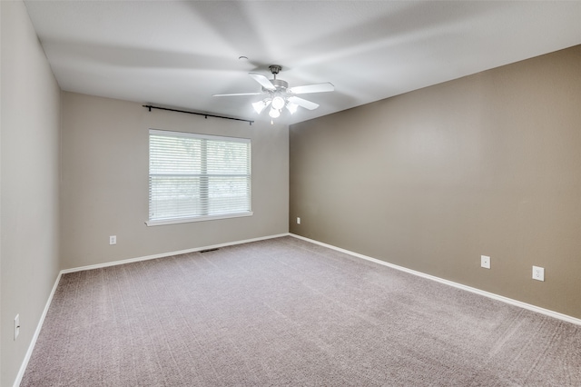 spare room featuring carpet floors and ceiling fan