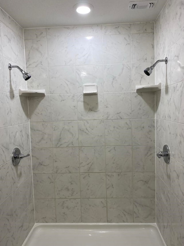 bathroom with tiled shower