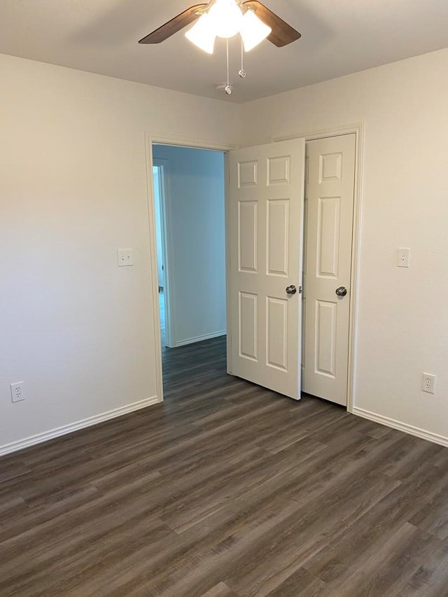 unfurnished bedroom featuring a closet, dark hardwood / wood-style floors, and ceiling fan