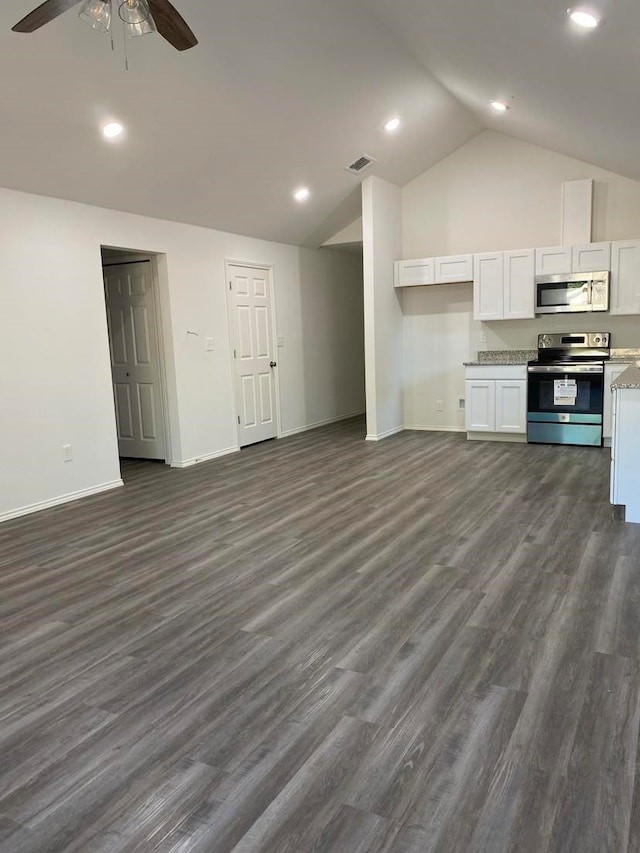 kitchen featuring lofted ceiling, dark wood-type flooring, white cabinets, appliances with stainless steel finishes, and ceiling fan