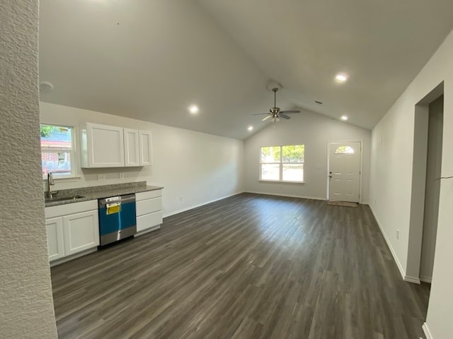 kitchen with lofted ceiling, dishwasher, white cabinets, and sink