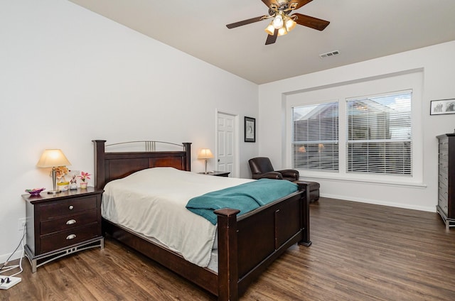 bedroom with visible vents, baseboards, wood finished floors, and a ceiling fan