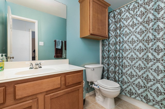 bathroom featuring tile patterned flooring, vanity, walk in shower, and toilet