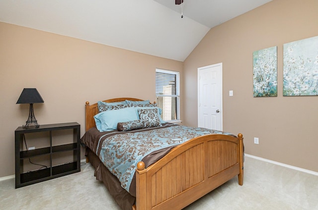 bedroom with lofted ceiling, a ceiling fan, baseboards, and light carpet