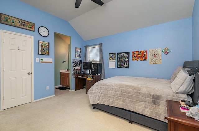 carpeted bedroom with vaulted ceiling, ceiling fan, and ensuite bathroom