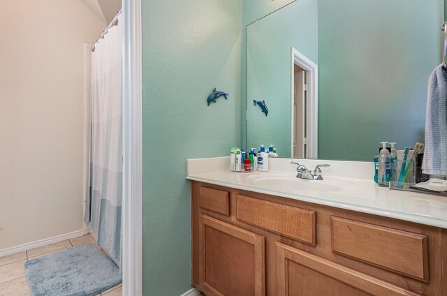 bathroom featuring tile patterned flooring, vanity, and a shower with curtain