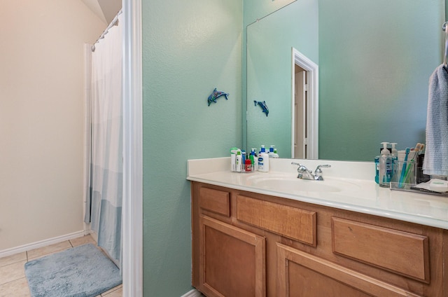 bathroom with tile patterned flooring, vanity, a shower with shower curtain, and baseboards