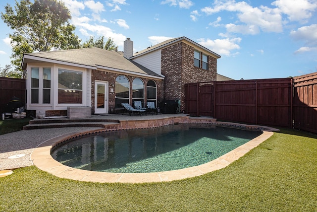 view of swimming pool with a yard, a fenced backyard, and a patio area