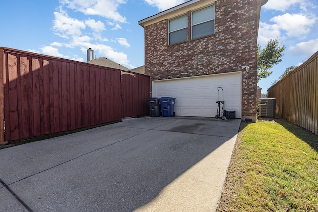 view of home's exterior with a garage and cooling unit