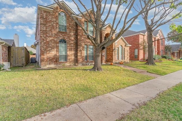 view of front facade featuring a front yard and brick siding