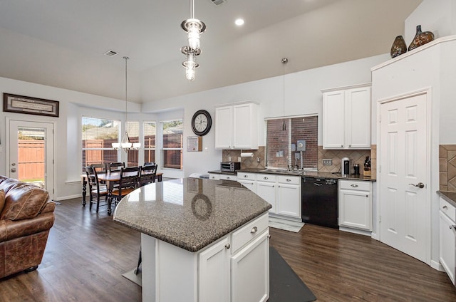 kitchen with pendant lighting, white cabinets, dishwasher, and a kitchen island