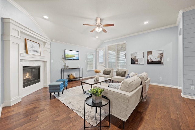 living room with ceiling fan, vaulted ceiling, dark hardwood / wood-style flooring, and crown molding