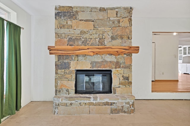 room details with ceiling fan and a fireplace