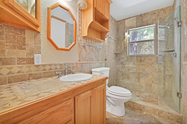 bathroom with a shower with door, toilet, tile walls, vanity, and a textured ceiling