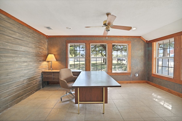 tiled home office with a textured ceiling and wooden walls