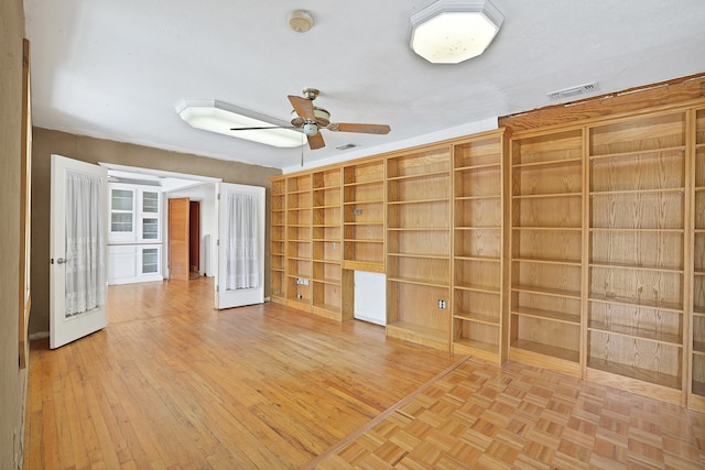 spare room featuring french doors, ceiling fan, and light hardwood / wood-style flooring