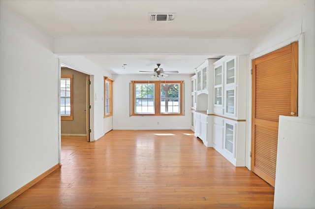 unfurnished living room with ceiling fan and light wood-type flooring