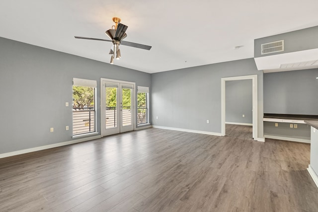 unfurnished living room featuring hardwood / wood-style flooring and ceiling fan