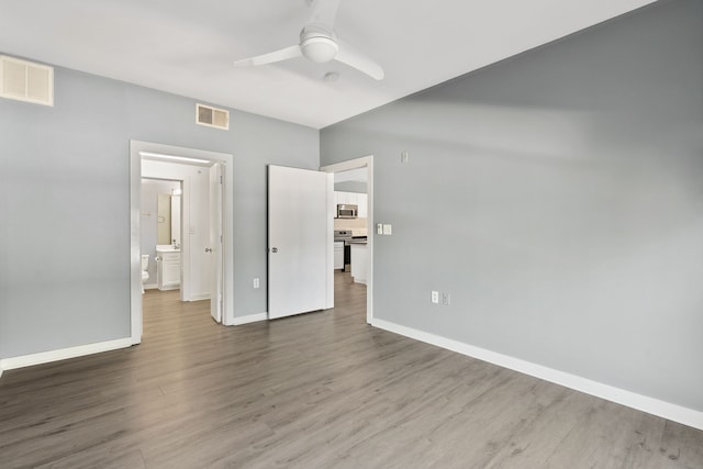 unfurnished bedroom with ceiling fan and wood-type flooring