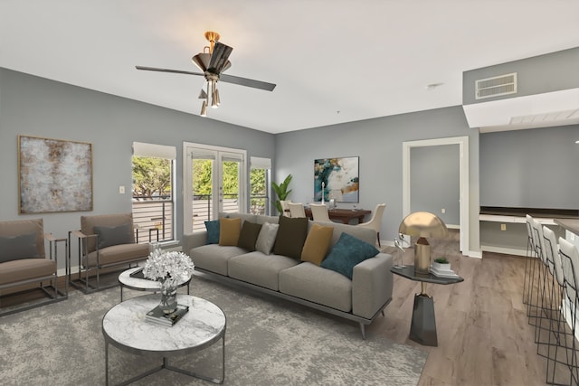 living room featuring hardwood / wood-style flooring and ceiling fan