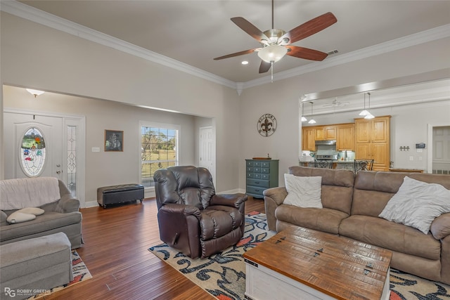 living room with ornamental molding, ceiling fan, and dark hardwood / wood-style flooring