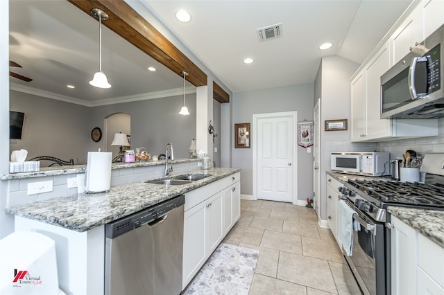 kitchen with white cabinetry, appliances with stainless steel finishes, sink, and hanging light fixtures