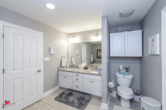 bathroom with vanity, toilet, and tile patterned flooring