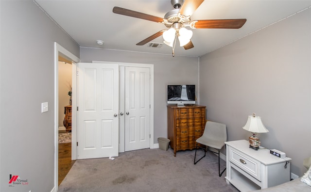 sitting room featuring light carpet and ceiling fan