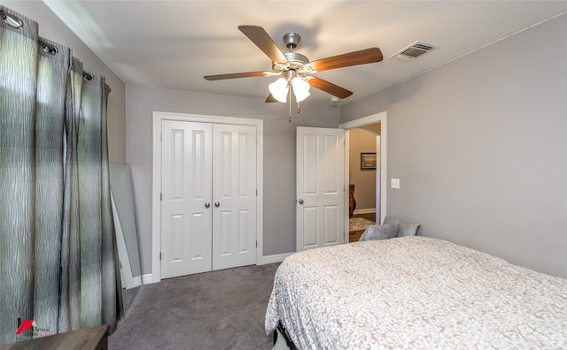 bedroom with a closet, ceiling fan, and dark carpet