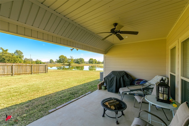 view of patio / terrace with an outdoor fire pit, area for grilling, a water view, and ceiling fan