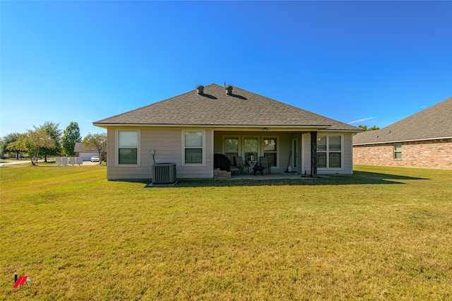 rear view of property featuring central AC, a yard, and a patio area