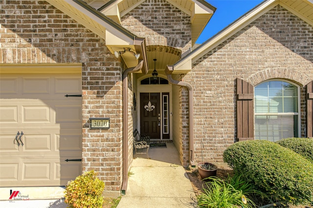 doorway to property with a garage