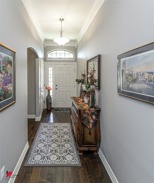 entryway with ornamental molding and dark hardwood / wood-style flooring