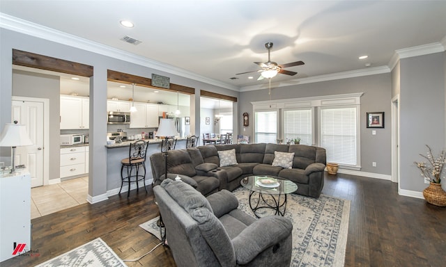 living room with crown molding, ceiling fan, and dark hardwood / wood-style flooring