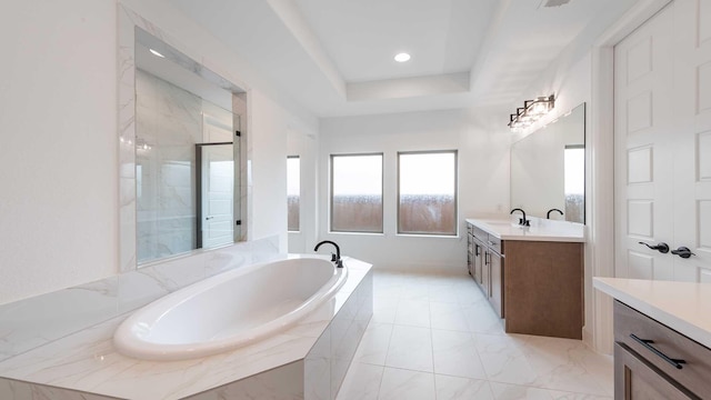 full bathroom with recessed lighting, vanity, a bath, a tray ceiling, and a stall shower