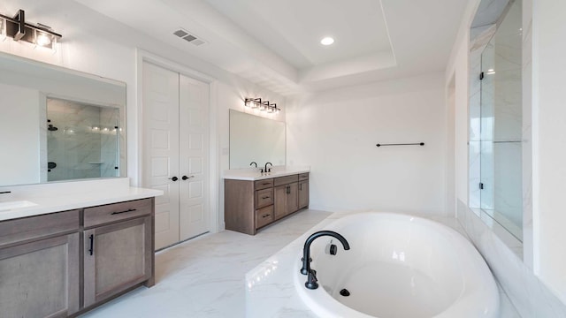 full bathroom featuring a garden tub, two vanities, visible vents, marble finish floor, and a stall shower