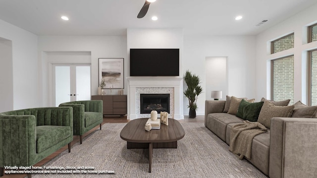 living room with recessed lighting, visible vents, a fireplace, and wood finished floors