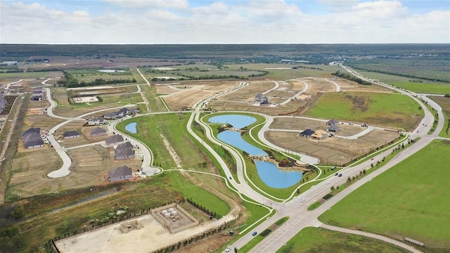 drone / aerial view featuring a rural view and a water view