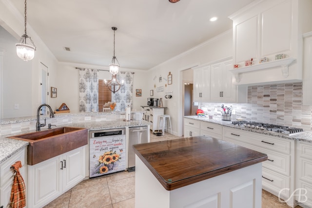 kitchen featuring kitchen peninsula, white cabinetry, stainless steel appliances, and a kitchen island