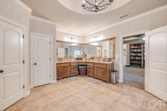 bathroom featuring an inviting chandelier, a textured ceiling, vanity, crown molding, and tile patterned flooring