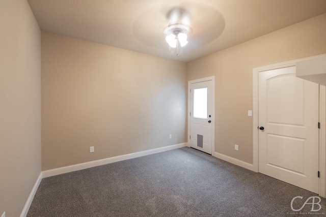 carpeted spare room with ceiling fan